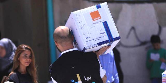 Orange Jordan employees participate in the distribution of food parcels to underprivileged families